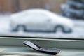 Old cell phone with car in snow Royalty Free Stock Photo