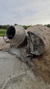 an old cement mixer machine by the pile of sand at the construction site. Royalty Free Stock Photo
