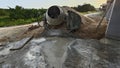 an old cement mixer machine by the pile of sand at the construction site. Royalty Free Stock Photo