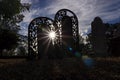 Old cemetary headstones with sunburst and lens flare