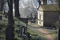 Old cemetery path between grave stones and crosses in spring Royalty Free Stock Photo