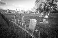 Old cemetery and tombstones in rural town, black and white Royalty Free Stock Photo