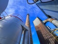 An old ceramic chimney and an old and new flue gas dust collector behind a coal boiler, a grate, against the blue sky Royalty Free Stock Photo