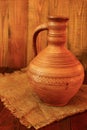 Old ceramic jug. Pitcher ceramic on sacking. Decanter ceramic brown on sacking Royalty Free Stock Photo