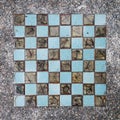 Old ceramic tiles like a chessboard, top view