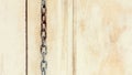 Old chains is hanging front an abandoned wood wall. Royalty Free Stock Photo