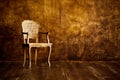 Old chair on a brown wall background. Royalty Free Stock Photo