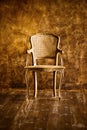 Old chair on a brown wall background. Royalty Free Stock Photo