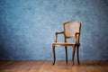 Old chair on a gray wall background. Royalty Free Stock Photo