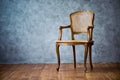 Old chair on a gray wall background. Royalty Free Stock Photo