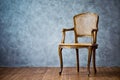 Old chair on a gray wall background. Royalty Free Stock Photo