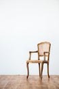 Old chair on a gray wall background. Royalty Free Stock Photo