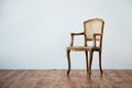 Old chair on a gray wall background. Royalty Free Stock Photo