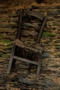 Old chair at stone wall