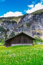 Old chalet on green mountain slope. Swiss Alps. Lauterbrunnen, S Royalty Free Stock Photo