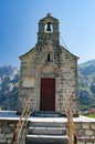Old chapel with a bell tower on the background of the mountains. Stairs, Church and bell tower.
