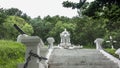 An old chapel of gray-white stones stands in a park on a hill.