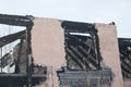 Old charred house without a roof and windows