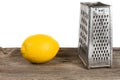 Old cheese grater and lemon Royalty Free Stock Photo