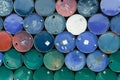 Old chemical barrels. Blue, green, and red oil drum. Steel oil tank. Toxic waste warehouse. Hazard chemical barrel with warning Royalty Free Stock Photo