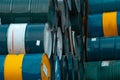 Old chemical barrels stack. Blue, green, and yellow chemical drum. Steel tank of flammable liquid. Hazard chemical barrel.