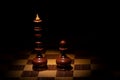 Old chess, pawn and queen on a dark background