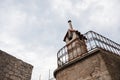 Old chimney made out of the red bricks on a roof with blue sky and white clouds in background. Royalty Free Stock Photo