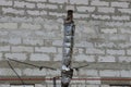 old chimney pipe in gray insulation at the brick wall of the building Royalty Free Stock Photo