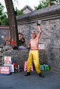 An old Chinese Kungfu master performs show on the street in Beijing, China