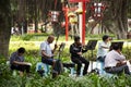 Old chinese people meet friends and sing song with playing classic musical instruments concert in park at Guangdong, China