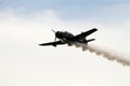 Old Chinese fighter plane flying and smoking Royalty Free Stock Photo