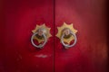 Old chinese red door with head metal knockers. Royalty Free Stock Photo