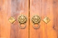 Old Chinese wooden door style with lion head knocker Royalty Free Stock Photo