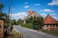 Old church and brick houses in Strzegomiany village, Sobotka, Poland. Royalty Free Stock Photo