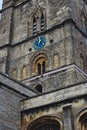 Church clock tower with blue clock face in the classic style in England Royalty Free Stock Photo