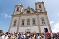 an old church with a crowd in front of it as the building is painted white