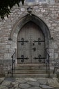 Old Church Entrance with Wooden Door and Stone Arch Royalty Free Stock Photo