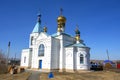 Old church with golden domes. It is built in a Siberian village. Russia. Royalty Free Stock Photo