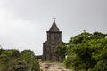 Old church in green trees landscape. Historical building on Bokor Hill. Abandoned church in forest Royalty Free Stock Photo