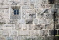 Old church stone wall with small window texture background Royalty Free Stock Photo