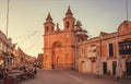 Old church on historical square with people having dinner at outdoor restaurant terrace