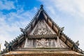 Old church isosceles made of wood on blue sky background