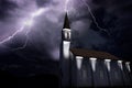 Old church at night during a thunderstorm, thunderbold hitting tower Royalty Free Stock Photo