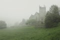 Old church surrounded by morning fog. Royalty Free Stock Photo