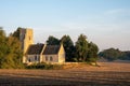 an old church surrounded by trees in a field near a country side Royalty Free Stock Photo