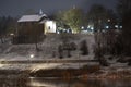 Old church on top of a hill at night in the light of a night street lamp. Night photo of the city. Building at the foot of the