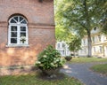 Old church wall with flowers in old centre of german town Aurich