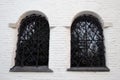 Old church windows decorated by metallic net. Royalty Free Stock Photo