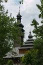 An old church with wooden domes in Transcarpathia in a green park