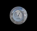 Old circular chrome thermometer on the black background isolated Royalty Free Stock Photo
